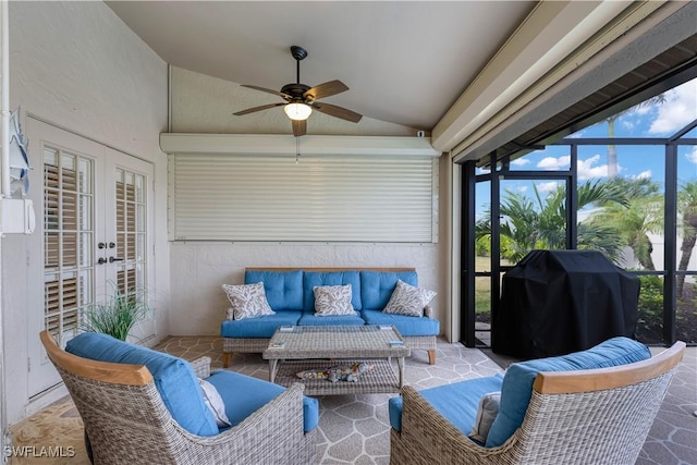 sunroom / solarium with ceiling fan, lofted ceiling, and french doors