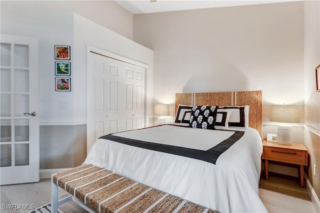 bedroom with light wood-type flooring and a closet