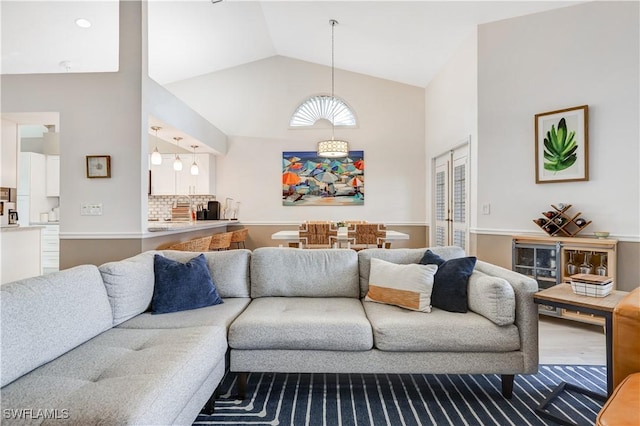 living room with vaulted ceiling and wood-type flooring