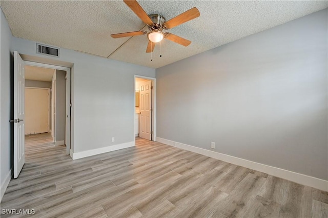 unfurnished bedroom featuring ceiling fan, a textured ceiling, and light hardwood / wood-style flooring