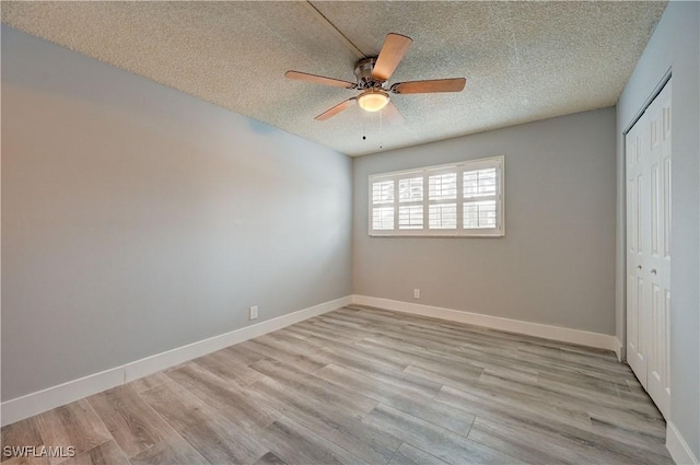 unfurnished bedroom featuring ceiling fan, light hardwood / wood-style flooring, a closet, and a textured ceiling