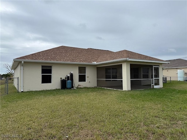 back of house featuring a lawn, central AC unit, and a sunroom