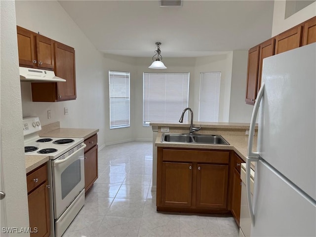 kitchen featuring white appliances, kitchen peninsula, light tile patterned floors, pendant lighting, and sink