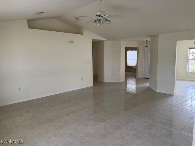 tiled empty room featuring lofted ceiling and ceiling fan