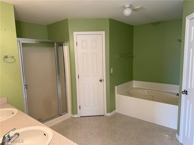 bathroom with vanity and shower with separate bathtub