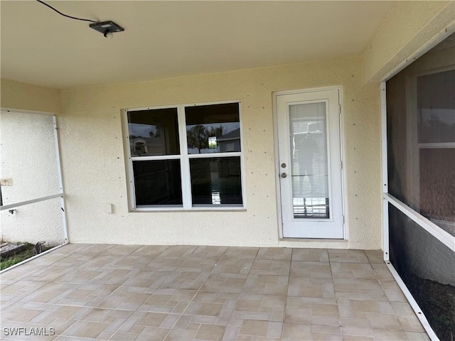 entrance to property with a patio