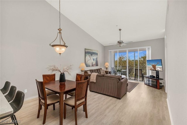 dining area with ceiling fan, lofted ceiling, and light hardwood / wood-style floors