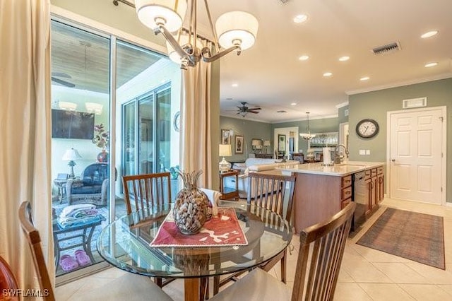 dining room with sink, ceiling fan with notable chandelier, crown molding, and light tile patterned flooring