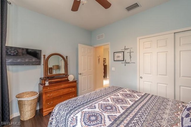 bedroom with a closet, hardwood / wood-style floors, and ceiling fan