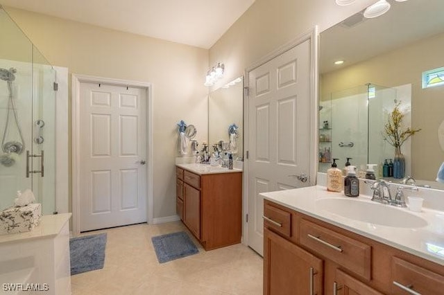 bathroom with a shower with shower door and vanity