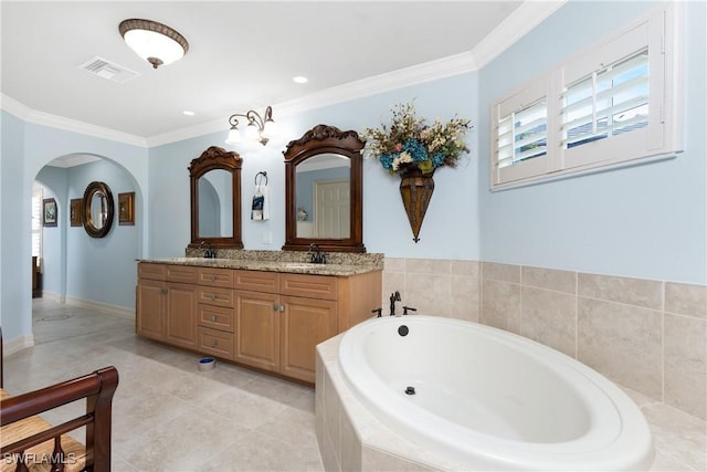 bathroom with tiled bath, ornamental molding, tile patterned floors, and vanity