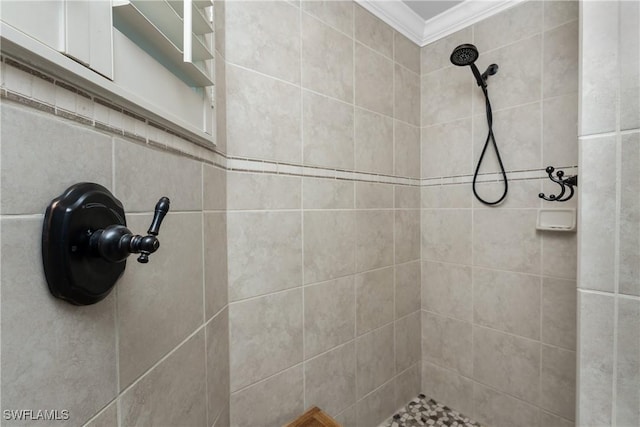 bathroom with tiled shower and crown molding