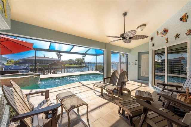 view of swimming pool with ceiling fan and a water view