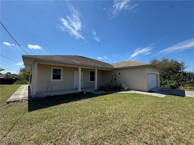 view of front of property featuring a garage, a front lawn, concrete driveway, and stucco siding