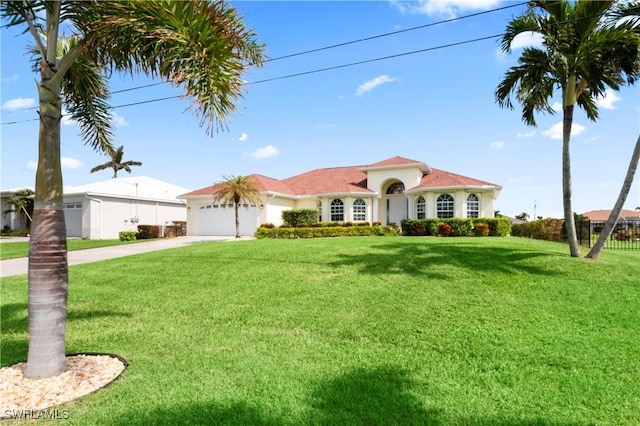 view of front facade featuring a garage and a front lawn