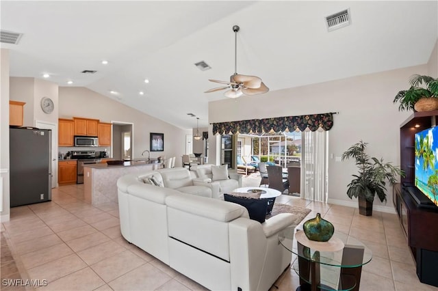 living room featuring vaulted ceiling, ceiling fan, light tile patterned flooring, and sink