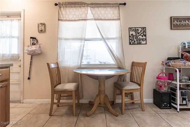 dining area featuring light tile patterned floors