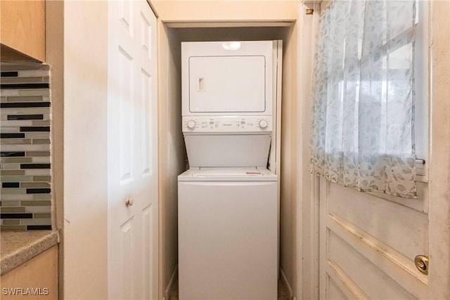 washroom with stacked washer and dryer