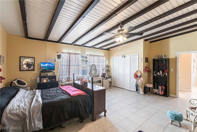 tiled bedroom featuring a closet, ceiling fan, and beam ceiling