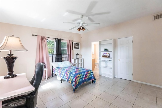 tiled bedroom with ensuite bathroom and ceiling fan