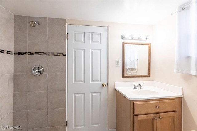 bathroom featuring vanity and tiled shower