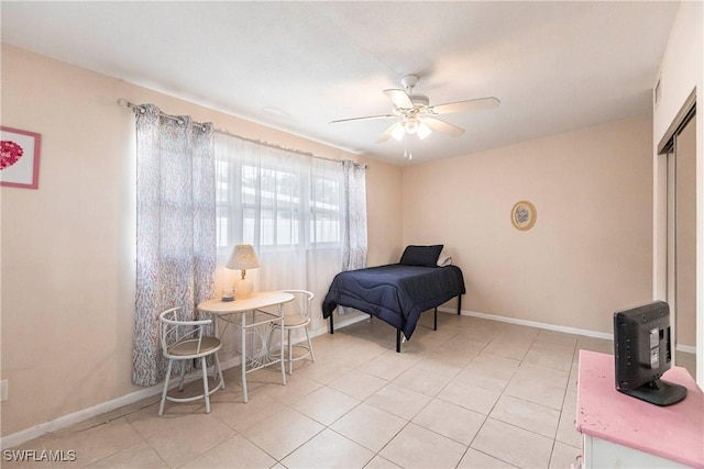 bedroom with light tile patterned flooring, a closet, and ceiling fan