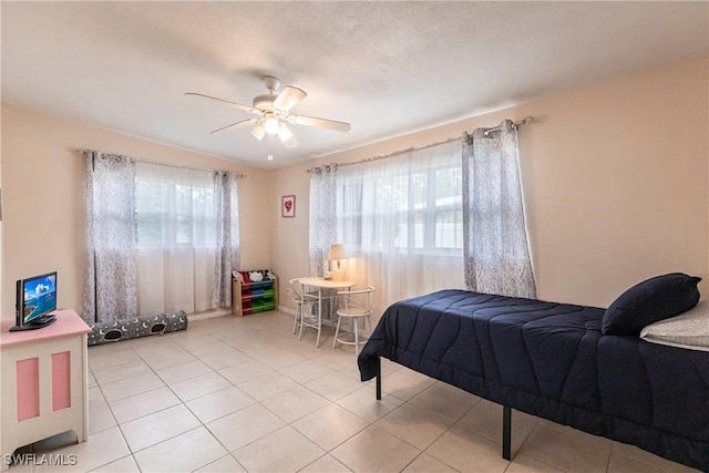 tiled bedroom with ceiling fan