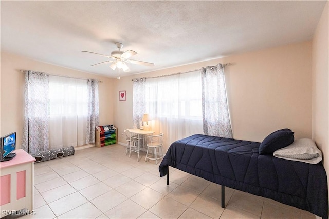 bedroom with ceiling fan and light tile patterned floors