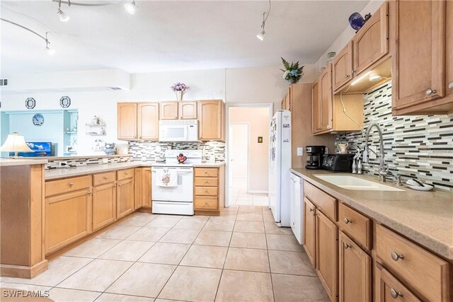 kitchen with tasteful backsplash, light tile patterned floors, sink, and white appliances