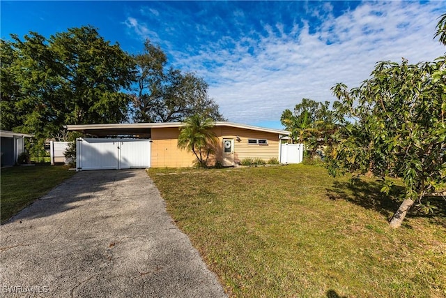 ranch-style house featuring a carport and a front lawn