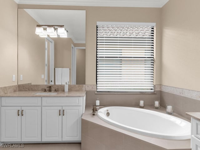 bathroom with tiled tub, vanity, and ornamental molding