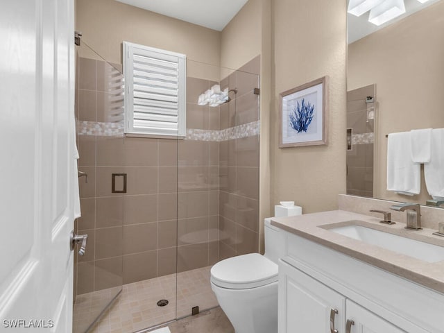 bathroom with vanity, toilet, and an enclosed shower