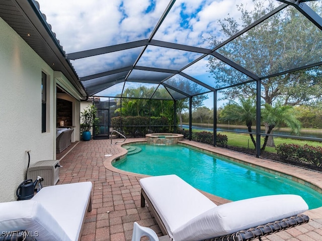 view of pool featuring an in ground hot tub, glass enclosure, and a patio area