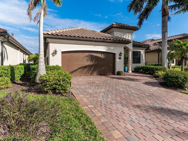 mediterranean / spanish home with a garage