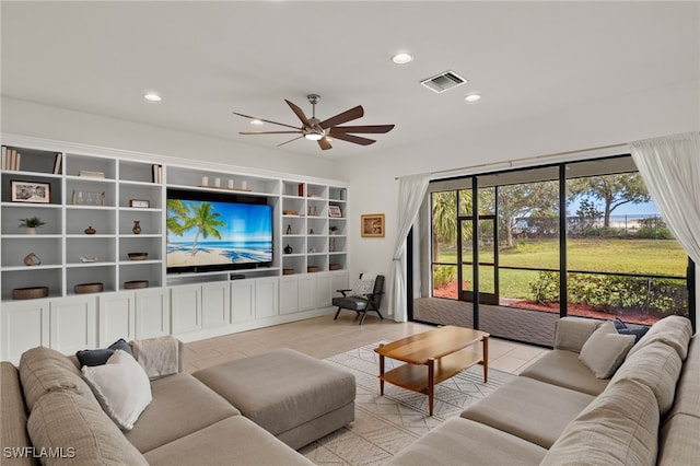 tiled living room with ceiling fan