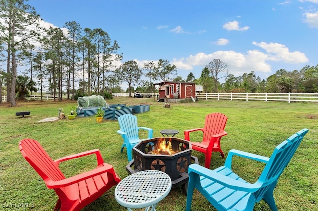 view of yard featuring an outdoor fire pit and an outdoor structure