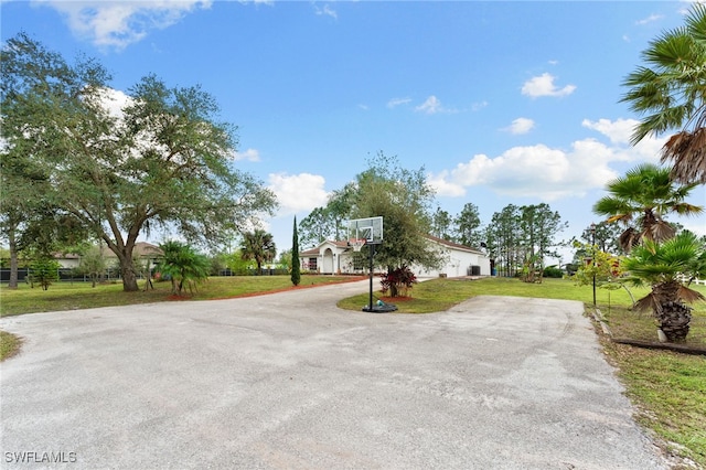 view of sport court featuring a yard