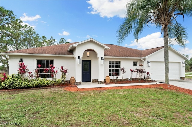 single story home featuring a garage and a front yard