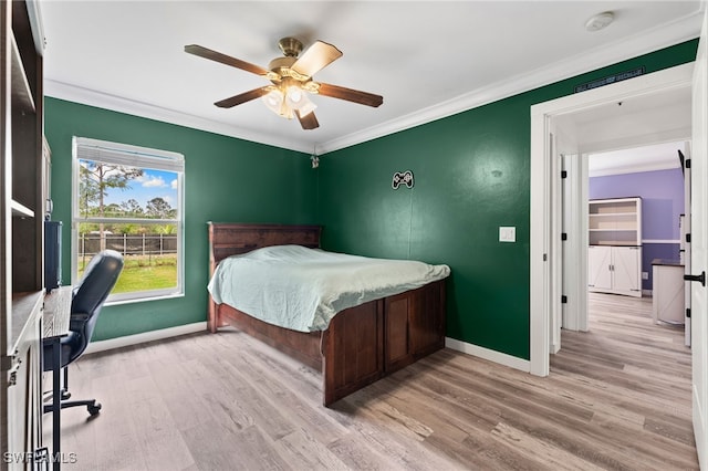 bedroom with ceiling fan, light hardwood / wood-style flooring, and crown molding