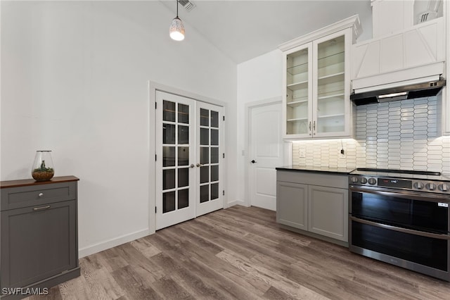 kitchen featuring lofted ceiling, french doors, decorative backsplash, double oven range, and gray cabinetry