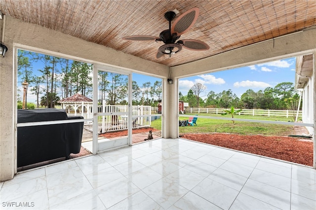 unfurnished sunroom with wooden ceiling and ceiling fan