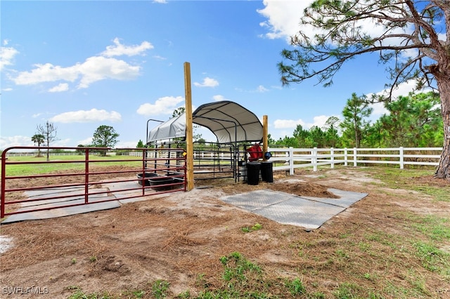 view of horse barn with a rural view