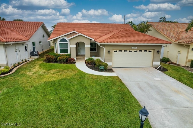 view of front of home with a garage, a front yard, and central AC unit