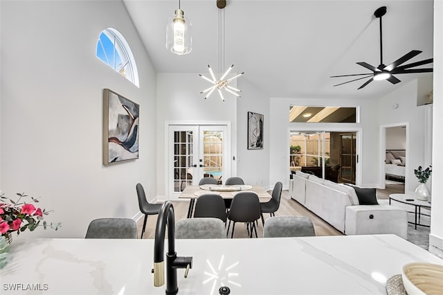 dining area featuring hardwood / wood-style flooring, ceiling fan, lofted ceiling, and french doors