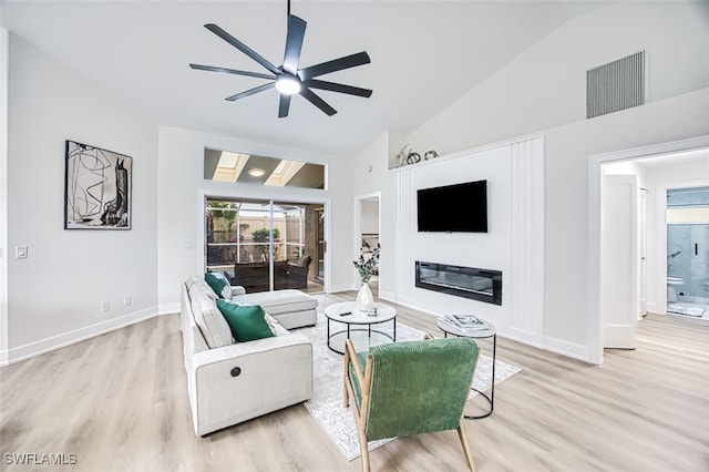 living room featuring ceiling fan, light wood-type flooring, and high vaulted ceiling