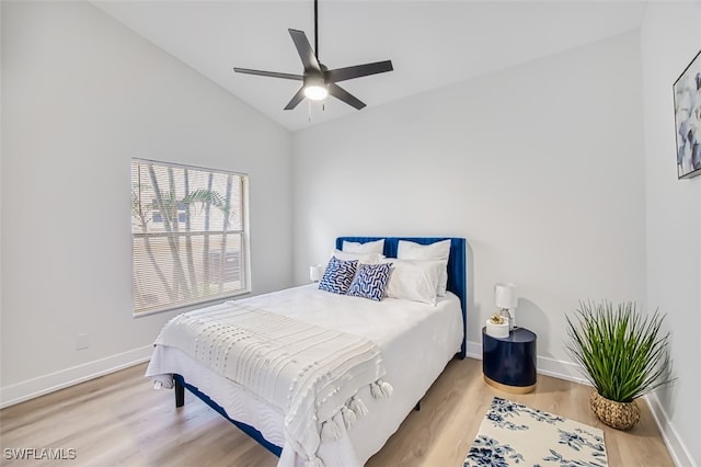 bedroom featuring ceiling fan, light hardwood / wood-style flooring, and high vaulted ceiling