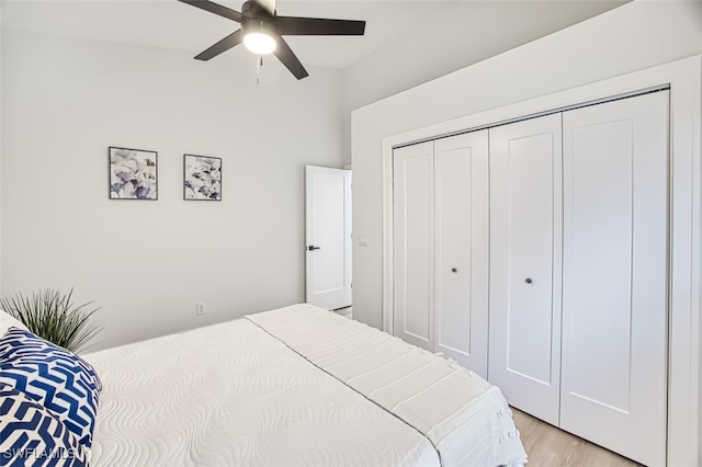 bedroom featuring ceiling fan, a closet, and light wood-type flooring