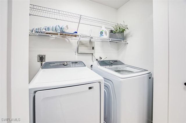 clothes washing area with washing machine and clothes dryer