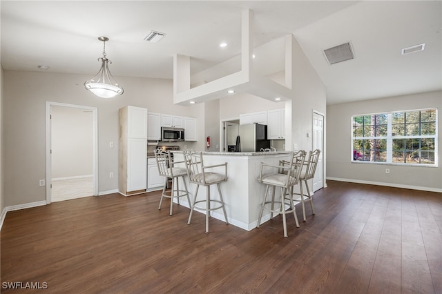 kitchen featuring visible vents, white cabinetry, stainless steel appliances, and light countertops