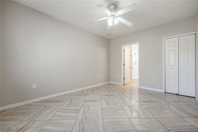 unfurnished bedroom featuring a closet, ceiling fan, and baseboards